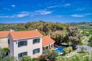 an aerial view of a house with a swimming pool at NEW! Villa SAN with heated pool, traditional surroundings, 3-bedrooms in Nerežišće