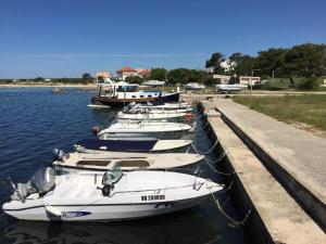 a row of boats are docked in the water at VillaMar in Pag