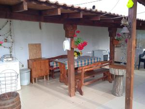 a room with a wooden table and a kitchen at Draganov House in Durankulak