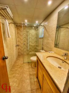 a bathroom with a sink and a shower and a toilet at Grand Islamabad Hotel in Islamabad