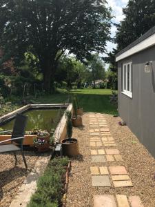a backyard with a swimming pool and a garden at Helens Cottage Otford Kent in Otford