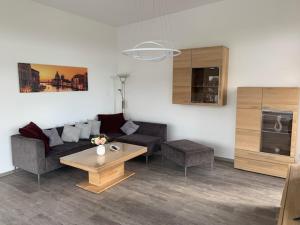 a living room with a couch and a coffee table at Urban Apartement-Boardinghouse Wadersloh in Wadersloh