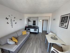 a living room with a couch and a piano at Apartments Matić in Baška Voda
