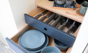 a drawer filled with blue plates and utensils at Kinelarty Luxury Glamping Pods Downpatrick in Downpatrick
