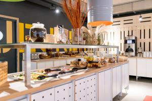 a buffet line with food on top of it at MEININGER Hotel Bordeaux Gare Saint-Jean in Bordeaux