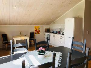 a kitchen and dining room with a table and chairs at Kastellegården in Kungälv