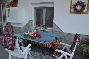 a table and chairs on a balcony with a window at KD Vintage Home in Lávrion