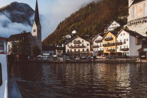a large body of water with houses and boats at Heritage Hotel Hallstatt in Hallstatt