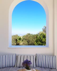a window in a room with a couch and a table at Paros Iliahtides Apartments near Golden Beach in Márpissa