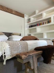 a bedroom with a bed and a wooden bench at B&B No. 42 in Valkenburg