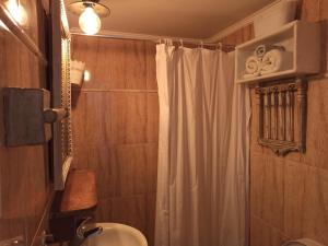 a bathroom with a shower curtain and a toilet at KD Vintage Home in Lavrio