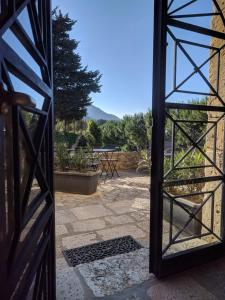 an open door with a view of a patio at Casale Ginisara in Castellammare del Golfo