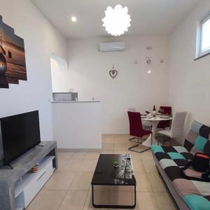 a living room with a couch and a table at Apartment Fran in Sonković