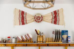 a shelf with plates and utensils on a wall at Traditional Boutique in Braşov