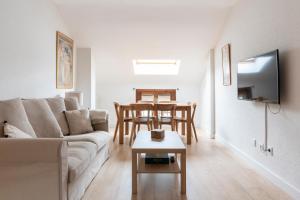 a living room with a couch and a table at Casa Pelaire Biescas in Biescas