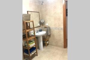 a bathroom with a sink and a mirror at Apartament amb parking privat a St Joan de les Abadesses in Sant Joan de les Abadesses +9 photos