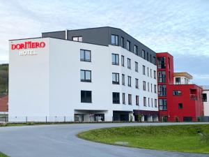 a large white building with a hotel sign on it at DORMERO Hotel Deggendorf in Deggendorf