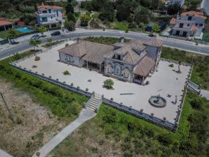 an aerial view of a large house with a yard at Casa Branca in Ericeira