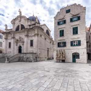 a large stone building in a courtyard at The Ragusa Arms in Dubrovnik