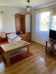 a living room with a couch and a coffee table at Domek wakacyjny in Charzykowy