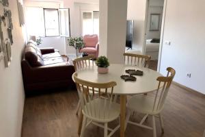a living room with a table and chairs and a couch at Beautiful and renovated apartment in the center in Valencia