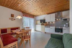 a kitchen and living room with a wooden ceiling at Bauernhof Oberlöffele in Jenig