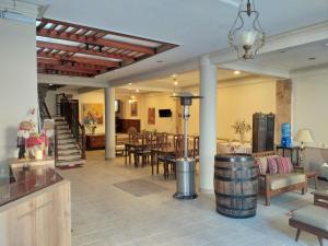 a room with a table and chairs and a wine barrel at Hotel Carmen in Tarija