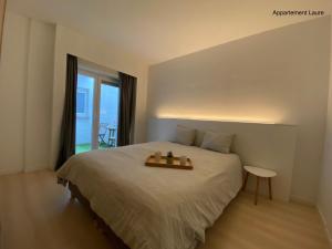 a bedroom with a bed with a table on it at Residentie Duinenzucht - Appartement Laure I Studio Lynne in Bredene