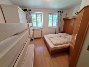 a small bedroom with a bed and a window at Zingst Achtern Diek 12d Elly in Zingst