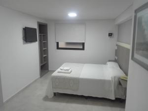 En eller flere senge i et værelse på Hotel Americano Pergamino + 43 billeder