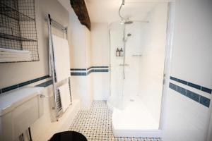 a white bathroom with a shower and a tub at Tower House Guest House in Oxford
