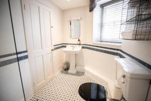 a bathroom with a tub and a sink and a toilet at Tower House Guest House in Oxford