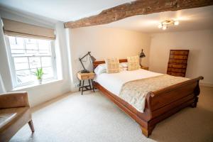 a bedroom with a bed and a window at Tower House Guest House in Oxford