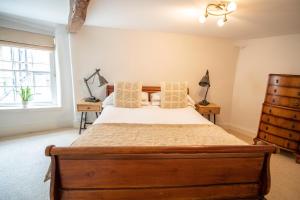 a bedroom with a bed and a window at Tower House Guest House in Oxford