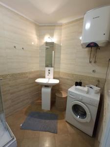 a bathroom with a washing machine and a sink at Sweet suite in Makarska