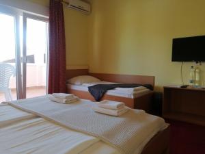 Postel nebo postele na pokoji v ubytování Apartmani Simon