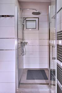 a walk in shower with a glass door at Apartment Gerber Krk in Krk
