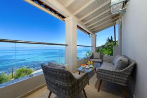a patio with chairs and a table with a view of the ocean at Villa Alexandra in Boukari