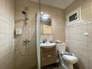 a bathroom with a shower and a toilet and a sink at SOHO Charming 55sqm apt in Athens in Athens