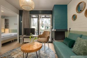 a living room with a couch and a table at Center Parcs Erperheide in Peer +90 photos