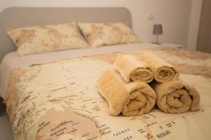 a bed with towels on top of a map at La Piazzetta in Lotzorai