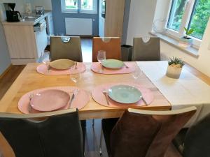 un tavolo con piatti e bicchieri sopra di Ferienwohnungen Rosenhof a Karlstadt