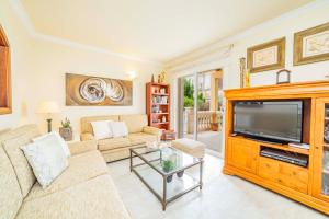 a living room with a couch and a television at Villa Esperanza in Alcudia