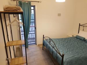 a bedroom with a bed and a balcony with a window at Case vacanza Controvento in Palermo