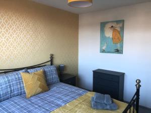 a bedroom with a bed and a picture on the wall at Rowan Place 5 Bedroom Off Street Parking Accommodation in Durham +2 photos