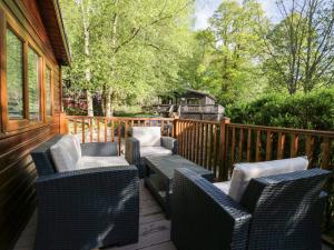 a group of chairs sitting on a deck at Mere Brook Lodge in Windermere