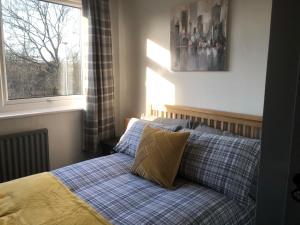 a bed with two pillows in a bedroom with a window at Rowan Place 5 Bedroom Off Street Parking Accommodation in Durham