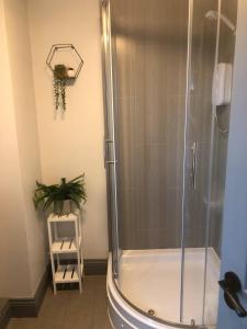 a shower with a glass door in a bathroom at Rowan Place 5 Bedroom Off Street Parking Accommodation in Durham