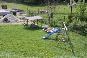 a playground with a slide and a swing at Feichten-Hof Zaiser Zimmer in Schleching