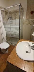 a bathroom with a sink and a shower and a toilet at CASA VACANZE FONDACO DI SCILLATO in Scillato